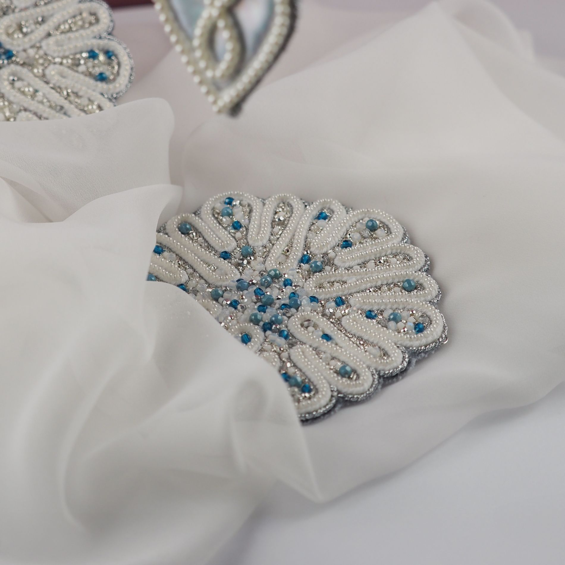 A finished Jewels of Winter ornament, hand embroidered with pearl beads, crystals and metallic details.