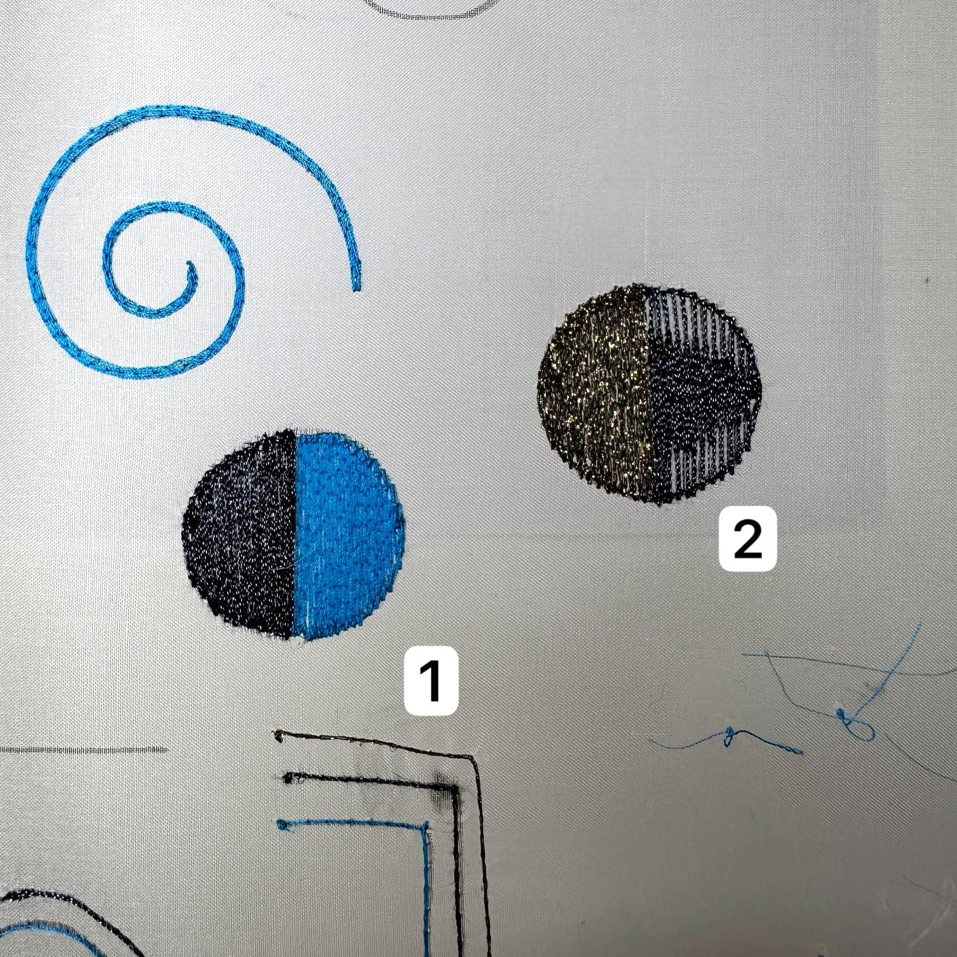 Lunéville embroidery student progress showing spiral stitch, filled circular samples, and line practice stitched with thread on silk organza